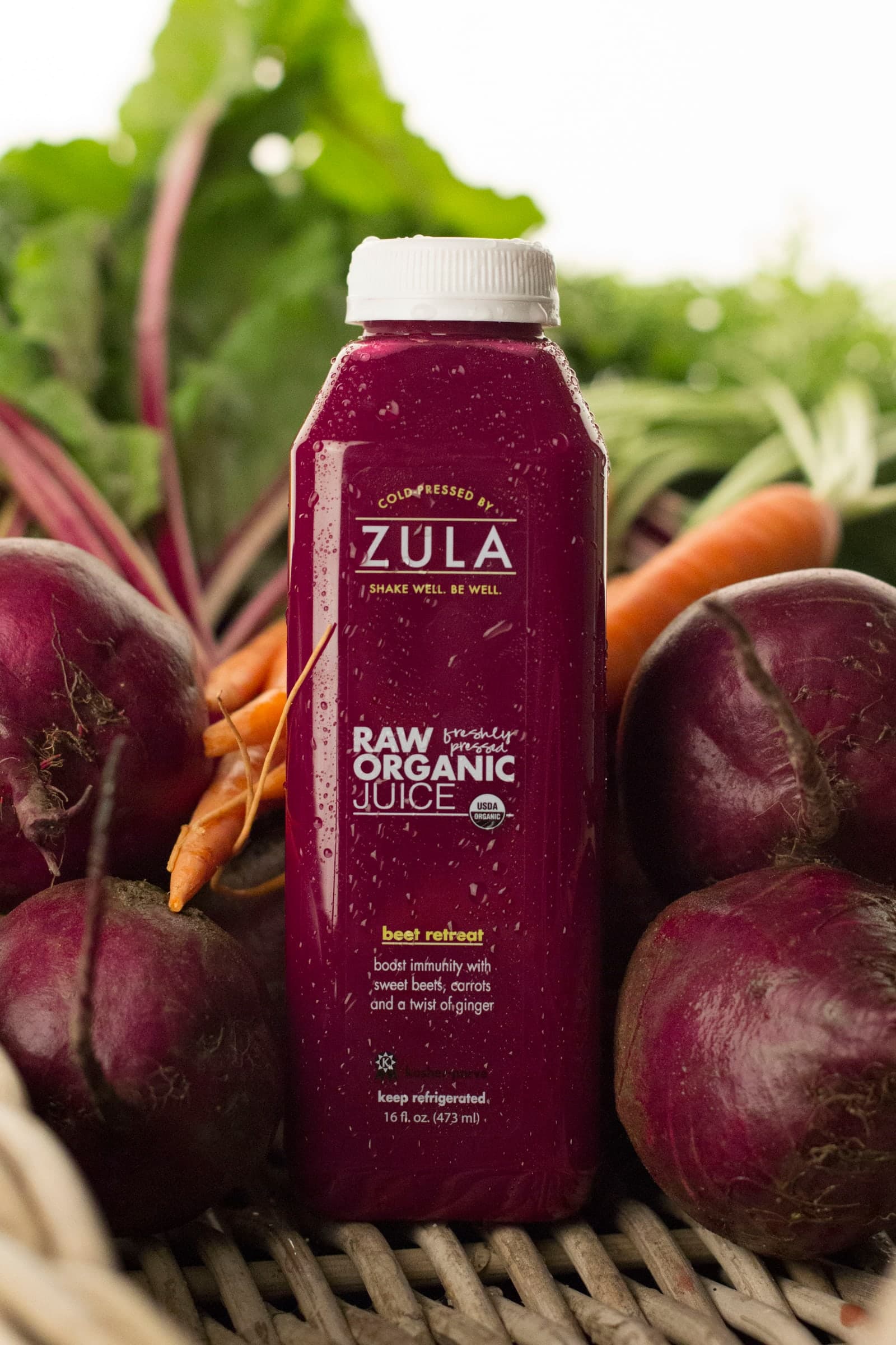 A beet-colored Zula bottle with produce, from the original Zula years.